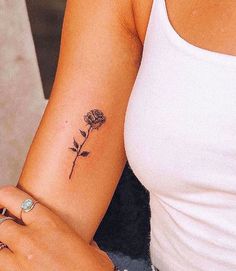 a woman with a rose tattoo on her arm