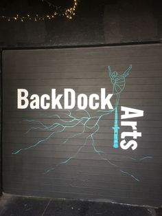 a garage door with the words backdock arts painted on it