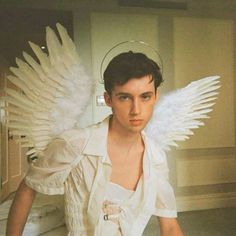 a young man with white wings on his head