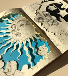 an open book with drawings on it and the pages cut out to look like sun and moon