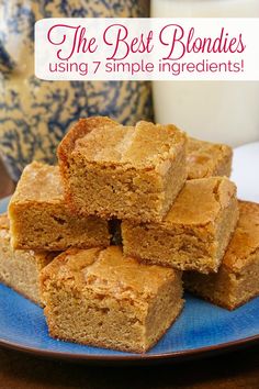 the best blondies using 7 simple ingredients are stacked on a blue plate next to a glass of milk