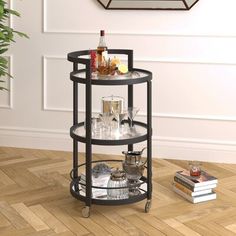 a table with drinks and glasses on it in a room next to a book shelf