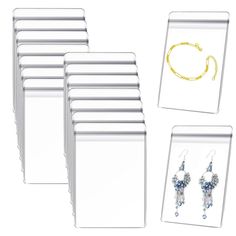 six pairs of earrings are shown in front of a white card with gold chains and beads