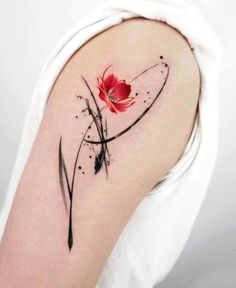 a woman's arm with a red flower on it and black lines in the middle