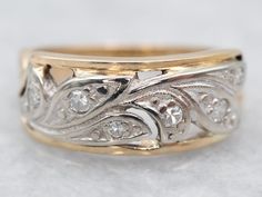 Polished yellow and white gold forms the gracefully flowing branch of this gorgeous diamond band. Sparkling and shining, the diamonds create a cool contrast to the vibrantly warm gold. This piece would make a special wedding band or romantic gift!Metal: 14K Yellow and White GoldGem: 6 Diamonds totaling .10 Carats, SI in Clarity, G-H in ColorWidth of Band: 6.8 mmHeight off Finger: 2.3 mmRing Size: 3.75Marks: "14K" Stamped on the inside band Gold Diamond Band, White Gold Wedding Bands, Botanical Jewelry, Rose Gold Band, Diamond Anniversary, White Gold Band, Vintage Botanical, Romantic Gift, Diamond Band