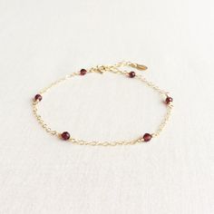 DESCRIPTIONThis dainty Garnet bracelet is hand wire wrapped with attention to detail. It's simple and elegant. A perfect bracelet to layer with other bracelets.DETAILS- Wire wrapped with 3mm Garnet beads- Total of 6 Garnet beads- Made in gold filled- Adjustable chain 6.5" - 7.5" Delicate Bracelet Gold, Garnet Bead Bracelet, Black Diamond Bracelet, Dainty Gold Bracelet, Garnet And Gold, Basic Jewelry, Garnet Bracelet, Birthstone Bracelet, Dainty Bracelet