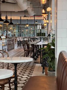 the inside of a restaurant with tables and chairs