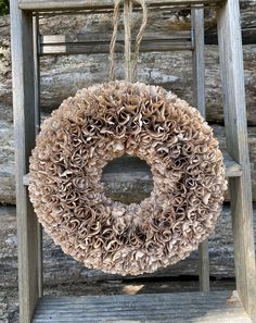 a wreath hanging from a wooden ladder