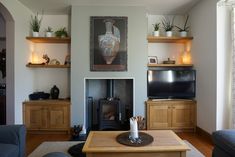 a living room filled with furniture and a fire place in front of a painting on the wall