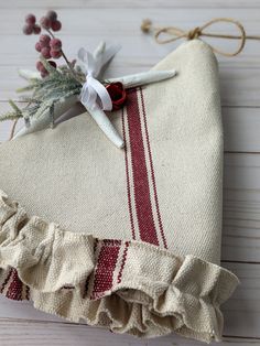 a piece of cloth with flowers on it sitting on a wooden table next to some twine