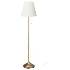 a gold floor lamp with a white shade on the base and a cord attached to it