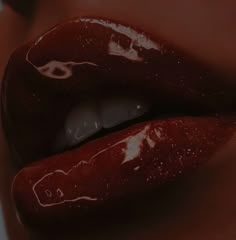 a woman's lips are covered in red liquid