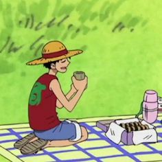 a man sitting on the ground eating food