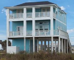 a blue and white house on the beach