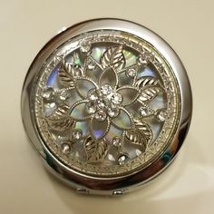 a compact case with an intricate design on it