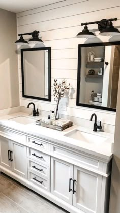 a bathroom with double sinks and two mirrors