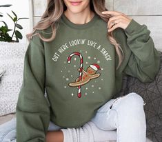 "Step up your winter wardrobe game with our Funny Holiday Sweater! This one-of-a-kind garment is not just a sweater, it's a conversation starter that will bring a dose of humor and festive spirit to any gathering. Our gingerbread man cookie Christmas sweater features a playful design of a gingerbread man gleefully sliding down a candy cane with the cheeky phrase \"out here looking like a snack\" emblazoned across the front. This sweater is more than a piece of clothing, it's a statement piece th Halloween Films, Halloween Film, Coffee Sweatshirt, Autumn Coffee, Emergency Room, Sweatshirt Christmas, Holiday Sweater, Christmas Coffee, Fall Sweatshirt