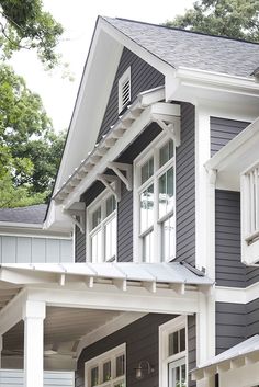 a gray house with white trim and windows