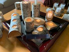 a tray with candles and logs on it