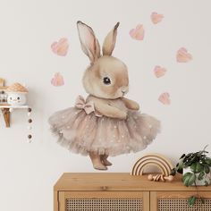 a rabbit in a tutu with hearts on the wall