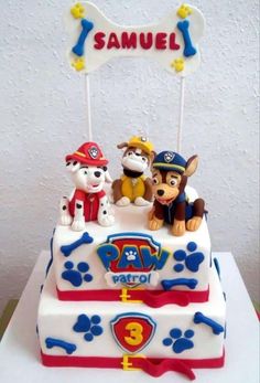 a birthday cake with three dogs on top