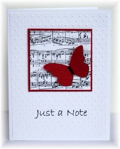 a card with a red butterfly on top of sheet music and the words just a note