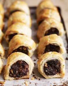 several pastries sitting on top of a baking pan covered in chocolate and other toppings