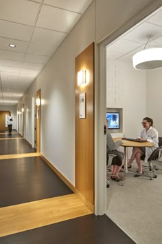 two people sitting at a table in an office