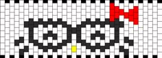 a cross stitch pattern with black and white squares in the shape of a cat's head