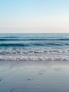 an ocean view with waves coming in to shore