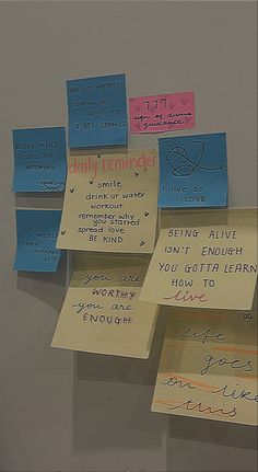 several sticky notes attached to a wall with writing on them that read daily reminders