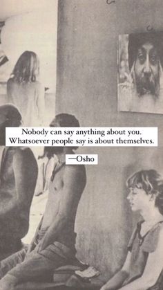 some people are sitting on the floor in front of pictures and one has a quote from osho