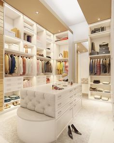 a walk in closet filled with lots of white furniture