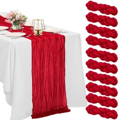 the table is set with red and white linens