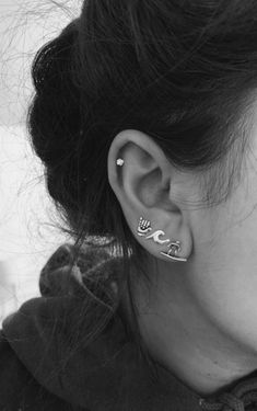 a close up of a person with ear piercings