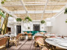 an indoor dining area with wicker chairs and tables