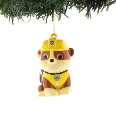 a christmas ornament with a monkey wearing a fireman's hat hanging from a tree