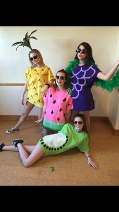 four women dressed in costumes posing for the camera