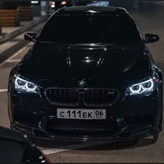 a black car parked in a parking lot at night