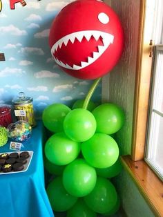 a bunch of balloons that are in the shape of a shark with teeth on it