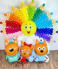 an assortment of balloons and decorations for a children's birthday party with cat characters