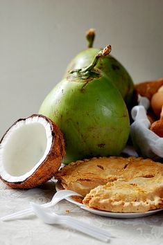 there are many different types of food on the table and one is coconut, another has an apple