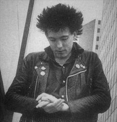 black and white photograph of a young man looking at his cell phone