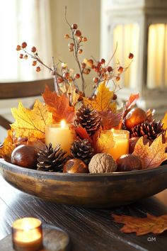 Cozy fall decor with candles, pinecones, and autumn leaves in a wooden bowl centerpiece. Perfect for high-end fall dining table decor ideas. Autumn Round Table Decor, Fall Table Display Ideas, Autumnal Table Decor, Luxurious Fall Decor, Fall Flower Arrangements For Home, Fall Office Decor Work, Autumn Table Centerpieces, Thanksgiving Floral Centerpieces, Diy Fall Centerpieces For Table