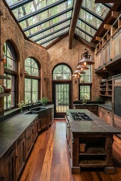 a large kitchen with an island and skylights in it's center windowed area