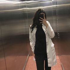 a woman taking a selfie in an elevator