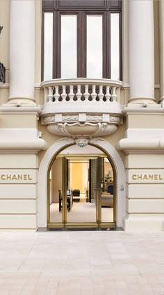 an entrance to a building with chandeliers and windows