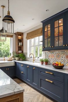 a kitchen with blue cabinets and marble counter tops