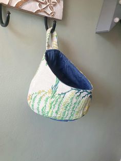 a purse hanging from a hook on the wall