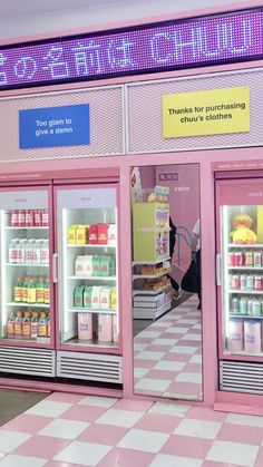 an empty store with pink walls and checkered flooring in front of the door